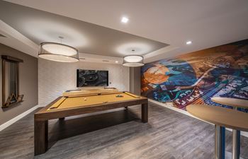 Resident social lounge and dining space with billiards table, chef's kitchen and flat screen tvs